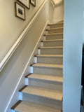 Elegance carpet shown as stair runner in a stair case enclosed by walls